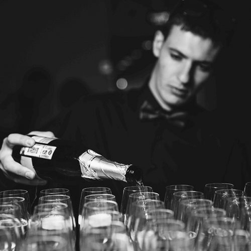 Bartenders serving champagne at NYC event.