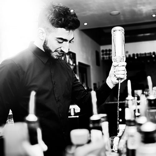 Mixologist making special cocktails at an event.